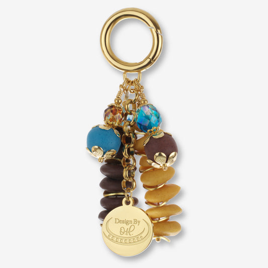 Odamea Bag Charm featuring dark brown, yellow, and aqua Ghanaian recycled glass beads with gold-plated accents.
