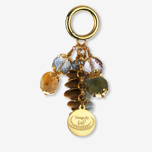 Osaebea Bag Charm with light blue and brown Ghanaian recycled glass beads and gold-plated accents.